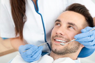 Man having teeth examined at dentists