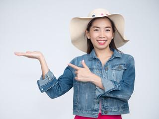 Portrait of beautiful asian woman with long hair in casual dress smiling cheerfully. Traveler tourist woman in jeans jacket on grey background.