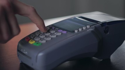 Close up hand young man use credit card terminal, making payment or withdraws money, enter pin code - Powered by Adobe