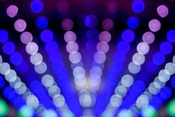 Closeup blue abstract blurred and bokeh of LED party light bubs reflection lighting at night time.