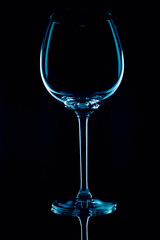 wine glass on black background in low key and reflections