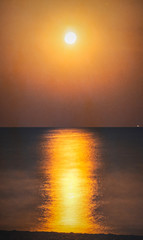 Fototapeta na wymiar Moonlit night over the sea. Full moon and lunar path