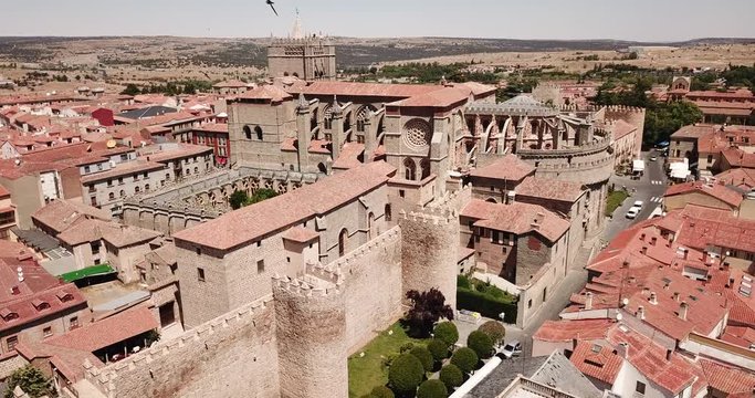 Aerial view of Gothic Cathedral of Saviour in Spanish fortified city of Avila on background of cityscape in summer day