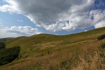 Fototapeta premium Bieszczady mountains in poalnd, landscape with hills and clouds over it