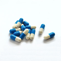 pills, capsules, white-blue on a white background