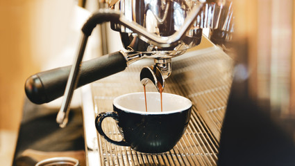 Espresso machine brewing a coffee. Coffee pouring into glasses in coffee shop, espresso pouring from coffee machine