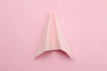 back to school. stationery, school supplies, paper airplane on a bright pink background. top view. minimalism concept