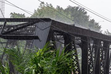 Heavy rainfall hitting steel structure during monsoon season in Malaysia