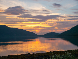 Fototapeta na wymiar Golden sunset mountains on the Norwegian sea