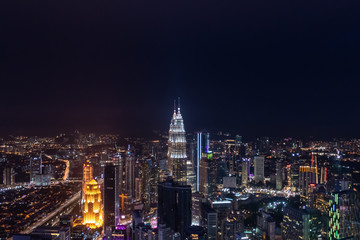 Fototapeta na wymiar Skyline of Kuala Lumpur during nighttime over viewing illuminated highrise buildings