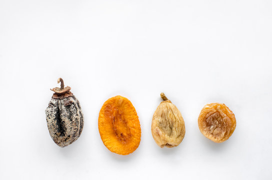 dried fruits lie on a white background, all kinds, rice, dried apricots, peach and grusha.Copy space