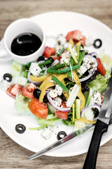 traditional greek salad with feta cheese and mixed organic vegetables