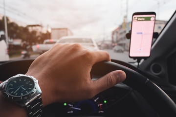 man using smartphone in a car and open map on smartphone