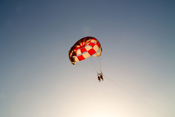 paragliding in the sky over the blue sea