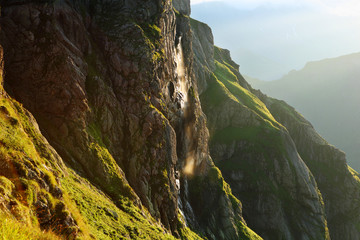 Waterfall in the light of the rising sun.