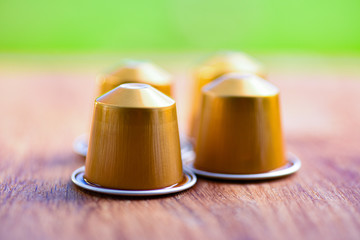 Coffee makes the world go around. 4 coffee capsules close up.