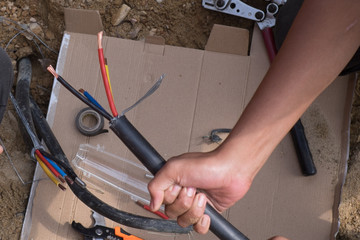 Electrical engineer technician fixing high voltage underground cable wire installation...