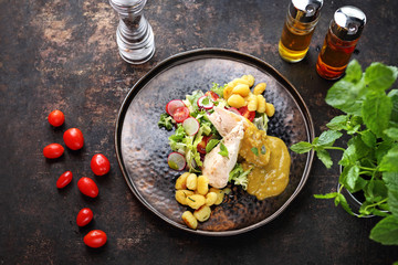 Chicken fillet in gorgonzola sauce served with gnocchi and green salad