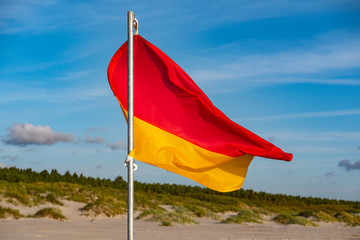 Red-yellow flag - pointer on the beach. They limit the area of the beach on which lifeguards attend.