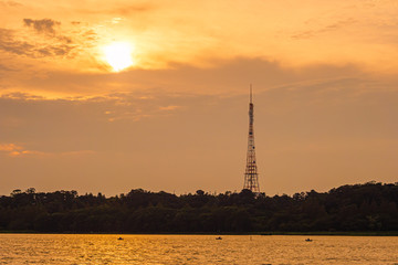 Lake and steel tower at sunset