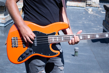 The guy plays an orange bass guitar