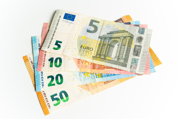 Obraz na płótnie Canvas Four Euro bills. Five, ten, twenty and fifty Euros in a waver