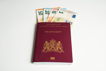 Dutch passport with Euros in it. Five, ten, twenty and fifty Euros