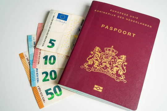 Dutch passport with Euros next to it. Five, ten, twenty and fifty Euros