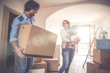 Young couple moving in into new apartment