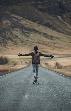 Skater traveling iceland on his longboard