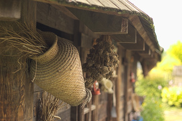 crafted straw bag on the old building in ethnographic, traditional park © ukasz
