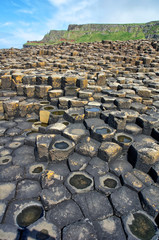 The Giant's Causeway  located in County Antrim, Northern Ireland. - obrazy, fototapety, plakaty