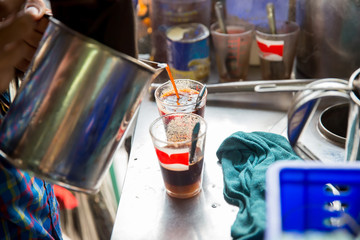 Brass tea kettle vintage style in local coffee cafeteria shop. ancient Asian coffee maker by filler bag and boiled water. image for objects, article and copy space.