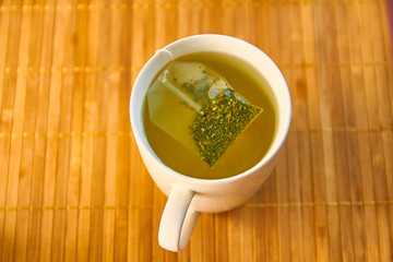 Tea brewing in a white tea cup isolated  