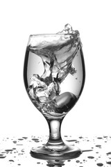 black and white image of a glass with water splashes