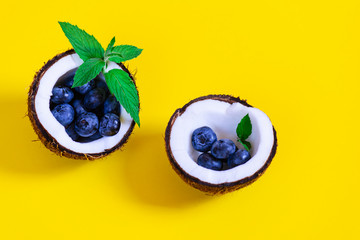 Blueberry with mint in a coconut.