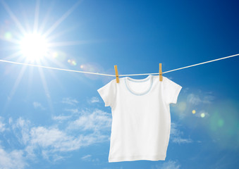 baby clothes hanging on a clothesline - Powered by Adobe