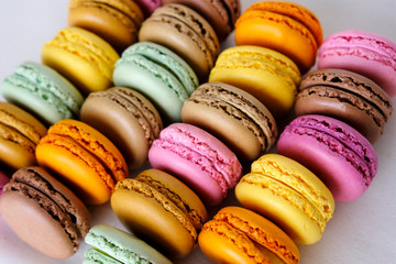 Colorful french macarons of different flavours. Delicious dessert, meringue based almond flour sandwich cookies