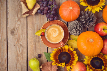 Autumn concept with pumpkin, apples and sunflowers on wooden table. Thanksgiving holiday background. Top view from above