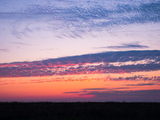 Beautiful Natural Sunset Sunrise Over Field. Landscape Colorful Sky