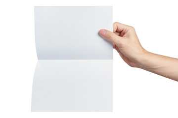 Fototapeta premium Hand holding a sheet of white paper, folded in half, isolated on white background