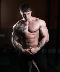 portrait of handsome male bodybuilder on dark background