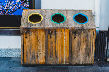 Garbage Trash Bins wooden. Recycling bins at a recycling station Recycling, translate is "General waste", "Plastic", "Can,Glass"