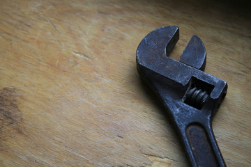 A spanner on a wooden board