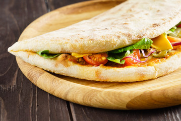 tasty pizza on the wooden background