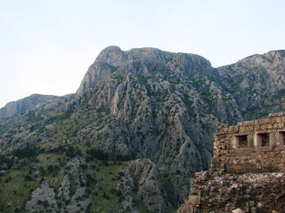Landscape from the top of a mountain on the surviving walls of a medieval fortress surrounded by high inaccessible rocks covered with poor vegetation.