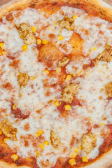 Hawaiian pizza on dark rustic wooden background. Top view, copy space