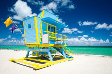 Bright scenic fine weather view of brightly painted lifeguard tower under sunny blue sky on South Beach, Miami, Florida