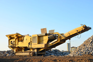 Mobile Stone crusher machine by the construction site or mining quarry for crushing old concrete...