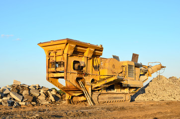 Mobile Stone crusher machine by the construction site or mining quarry for crushing old concrete...